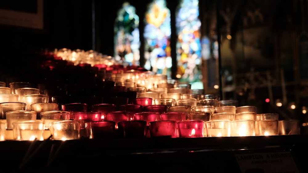 red candles on glass containers