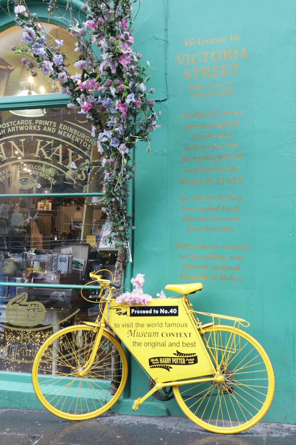 yellow bicycle with basket near green wall