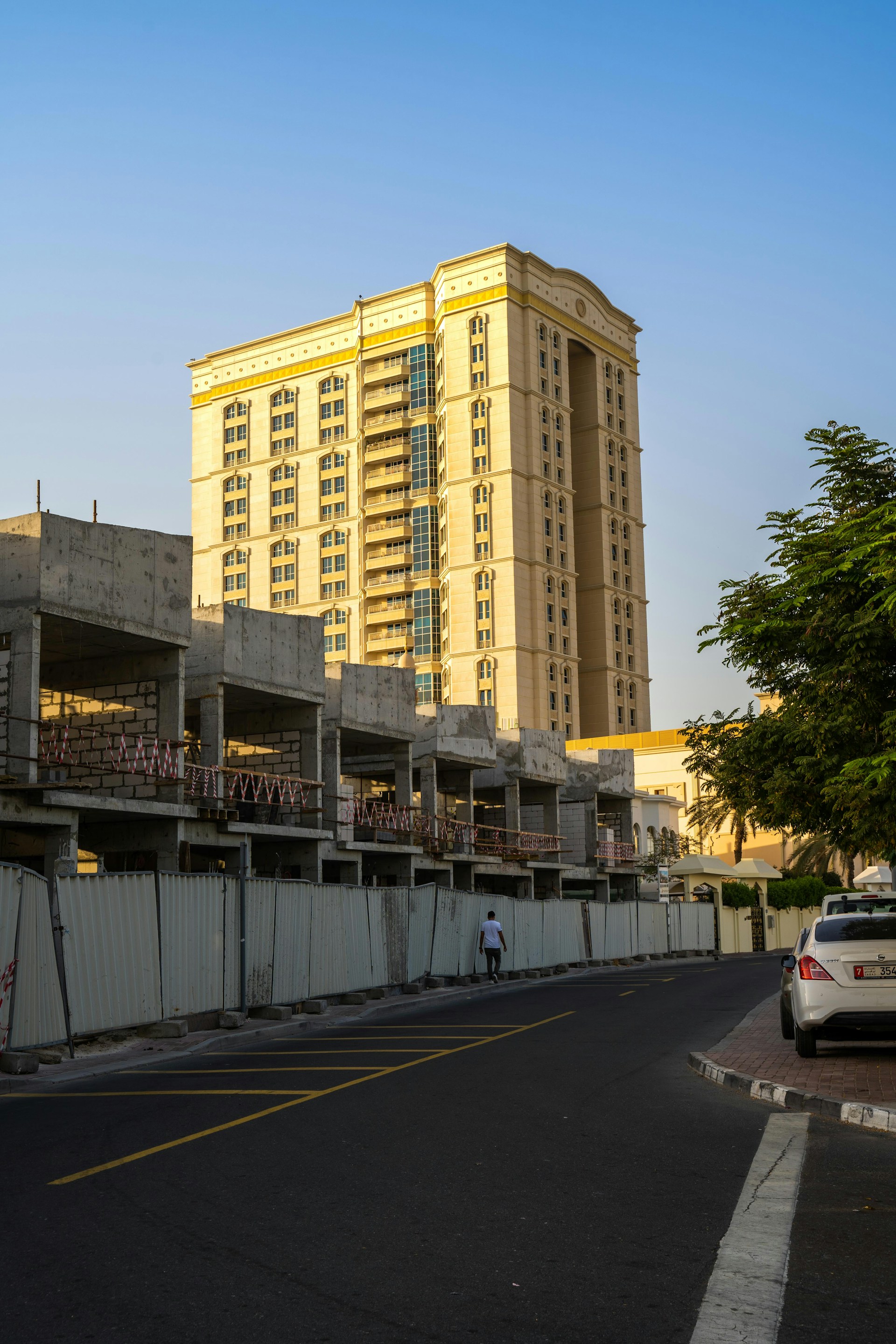 white car on road near building during daytime