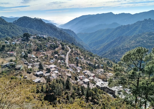aerial view of city near green mountains during daytime in Nainital India