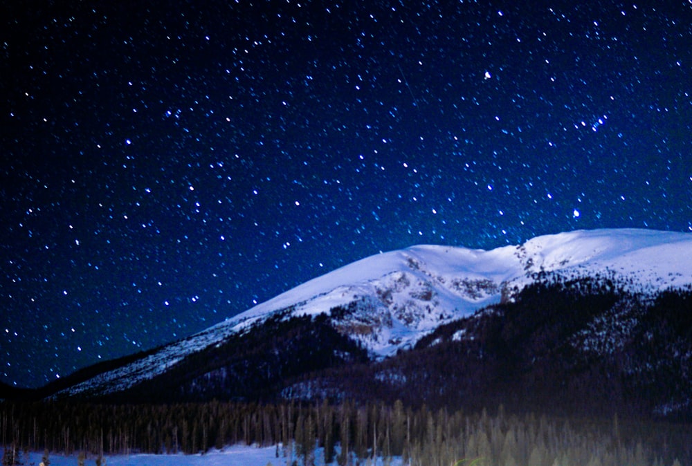 snow covered mountain during night time