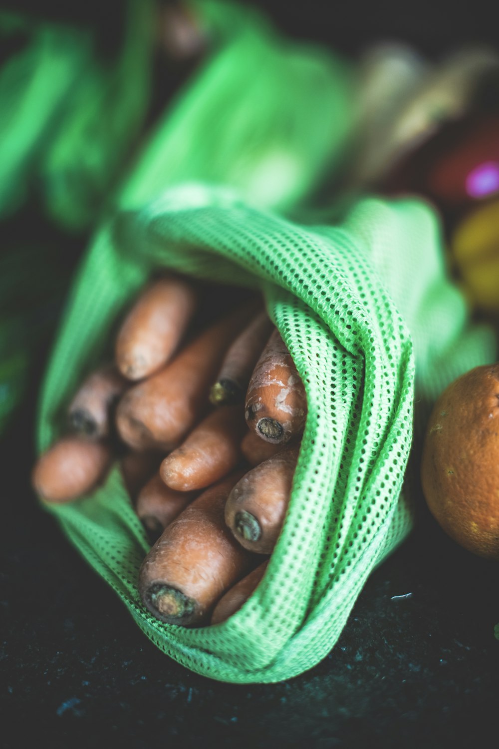 brown round fruit on green textile