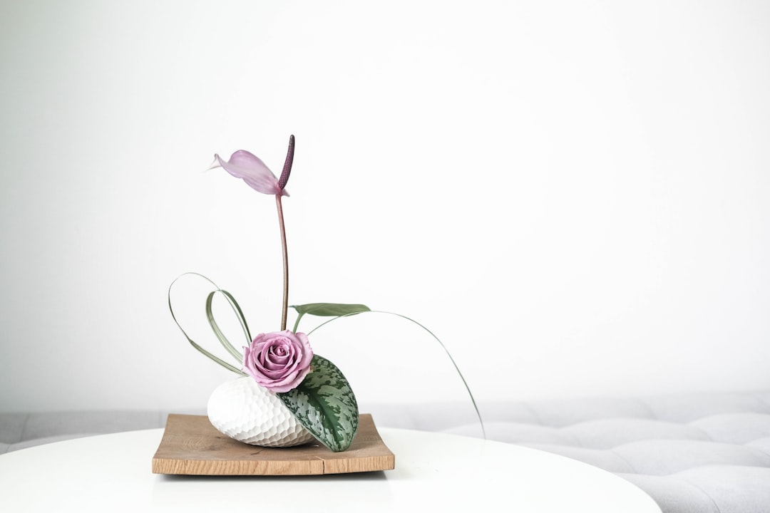 green and white ceramic vase on brown wooden table, Ikebana flower arrangement - ceramic vase