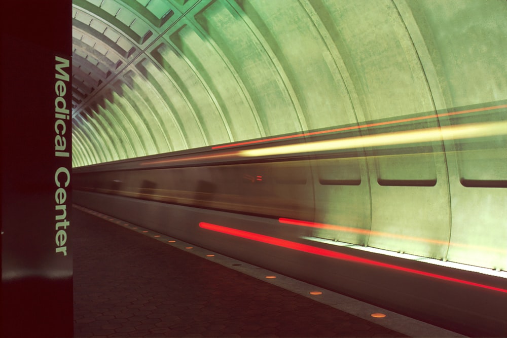 red and white train in a tunnel