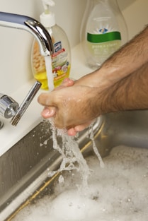 person holding yellow labeled can