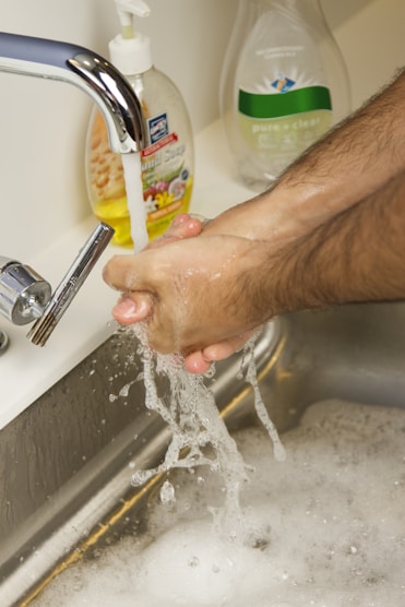 person holding yellow labeled can