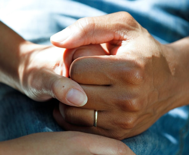 person wearing gold wedding band