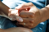 person wearing gold wedding band