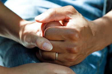 person wearing gold wedding band