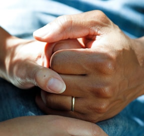 person wearing gold wedding band