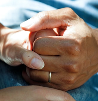 person wearing gold wedding band