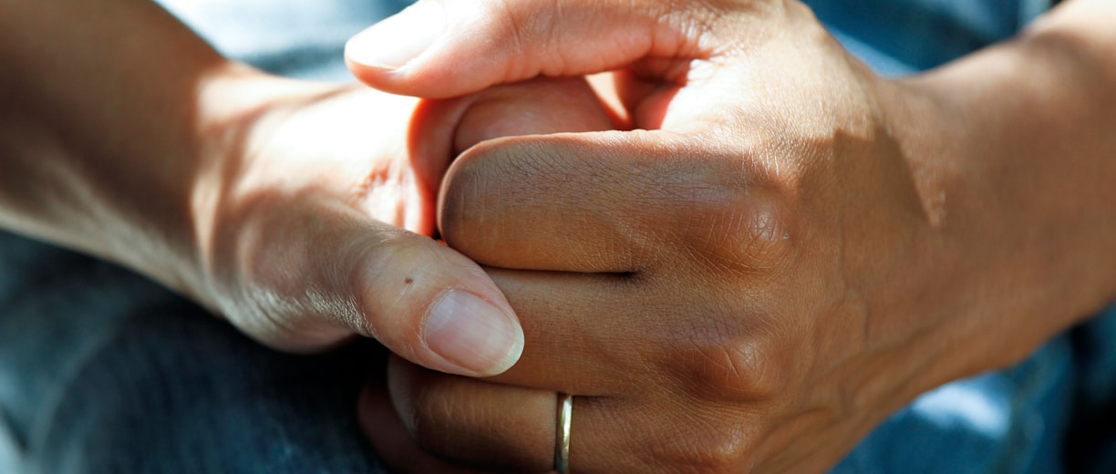 person wearing gold wedding band