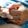 person wearing gold wedding band