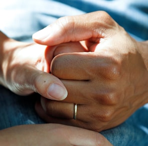 person wearing gold wedding band