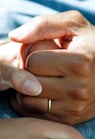 person wearing gold wedding band