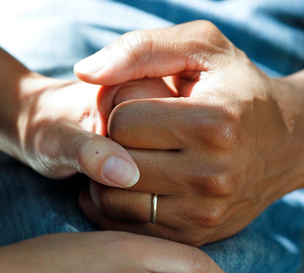 person wearing gold wedding band