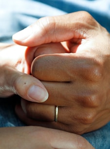 person wearing gold wedding band