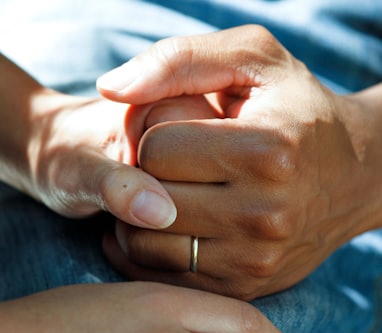 person wearing gold wedding band