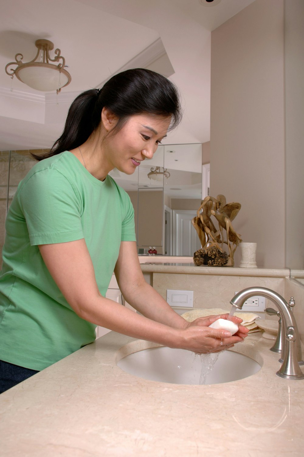 woman in green crew neck t-shirt holding white ceramic bowl