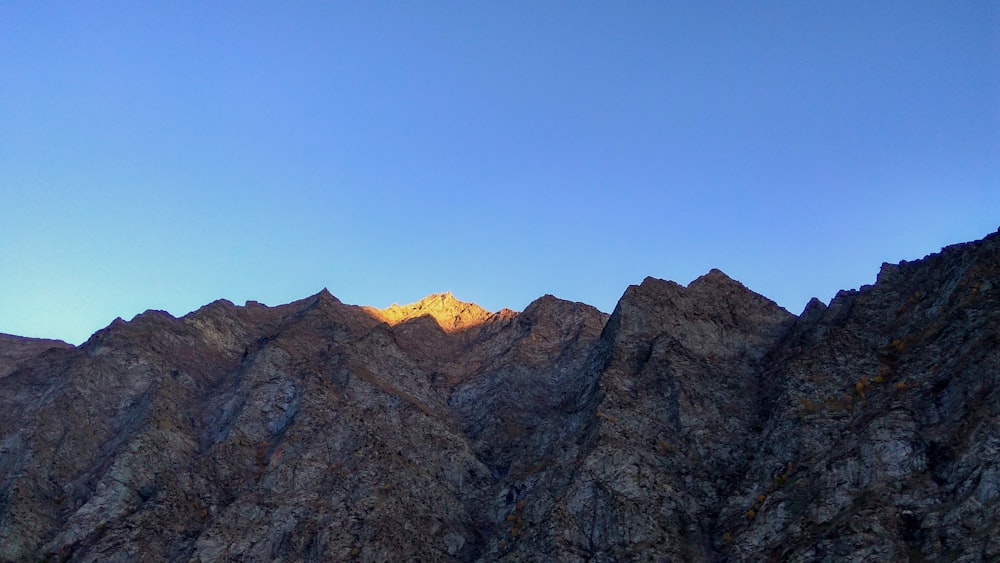 a view of the top of a mountain at sunset