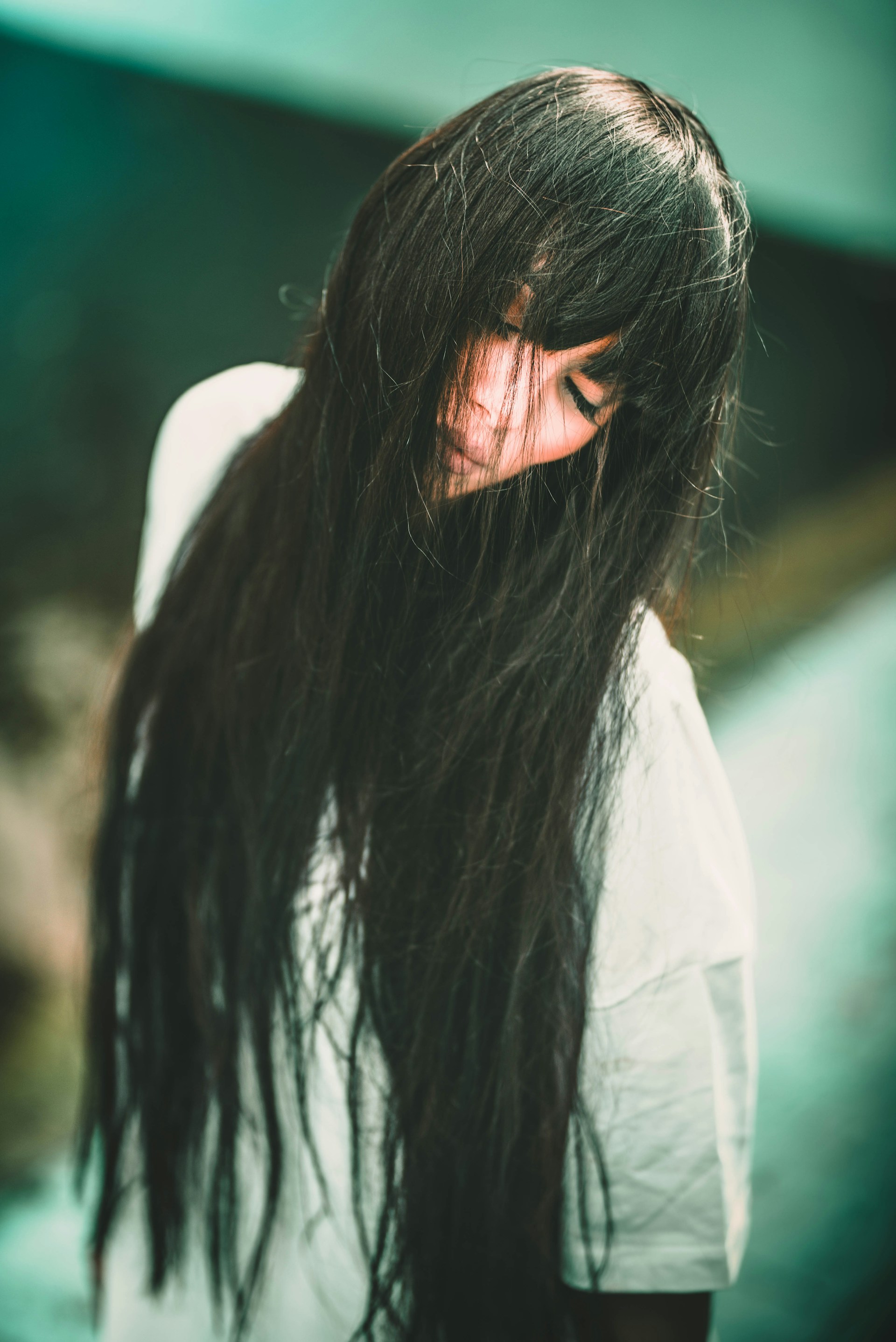 woman in white shirt with black hair