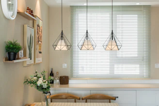 brown wooden table near white window blinds