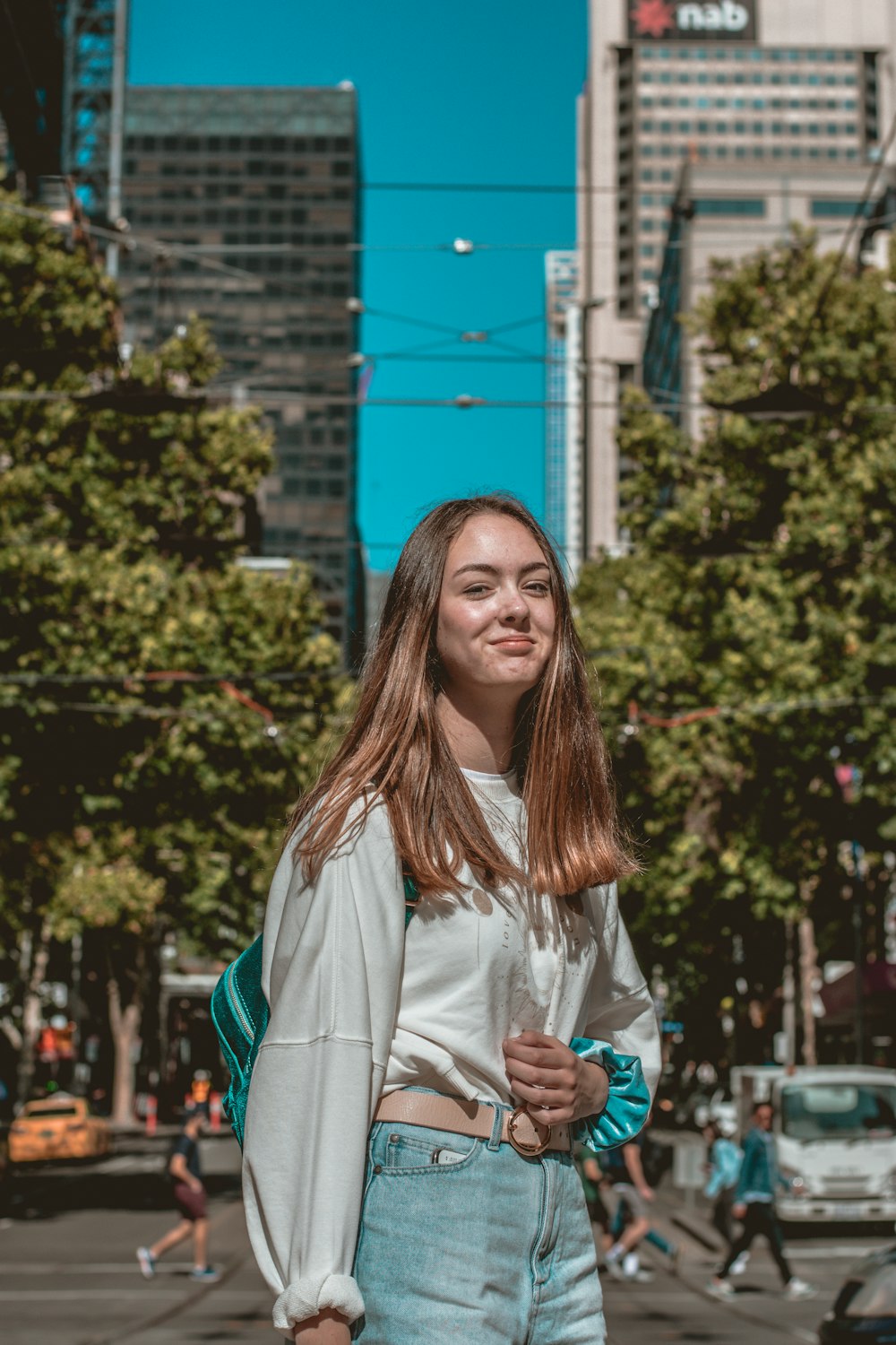 woman in white long sleeve shirt smiling