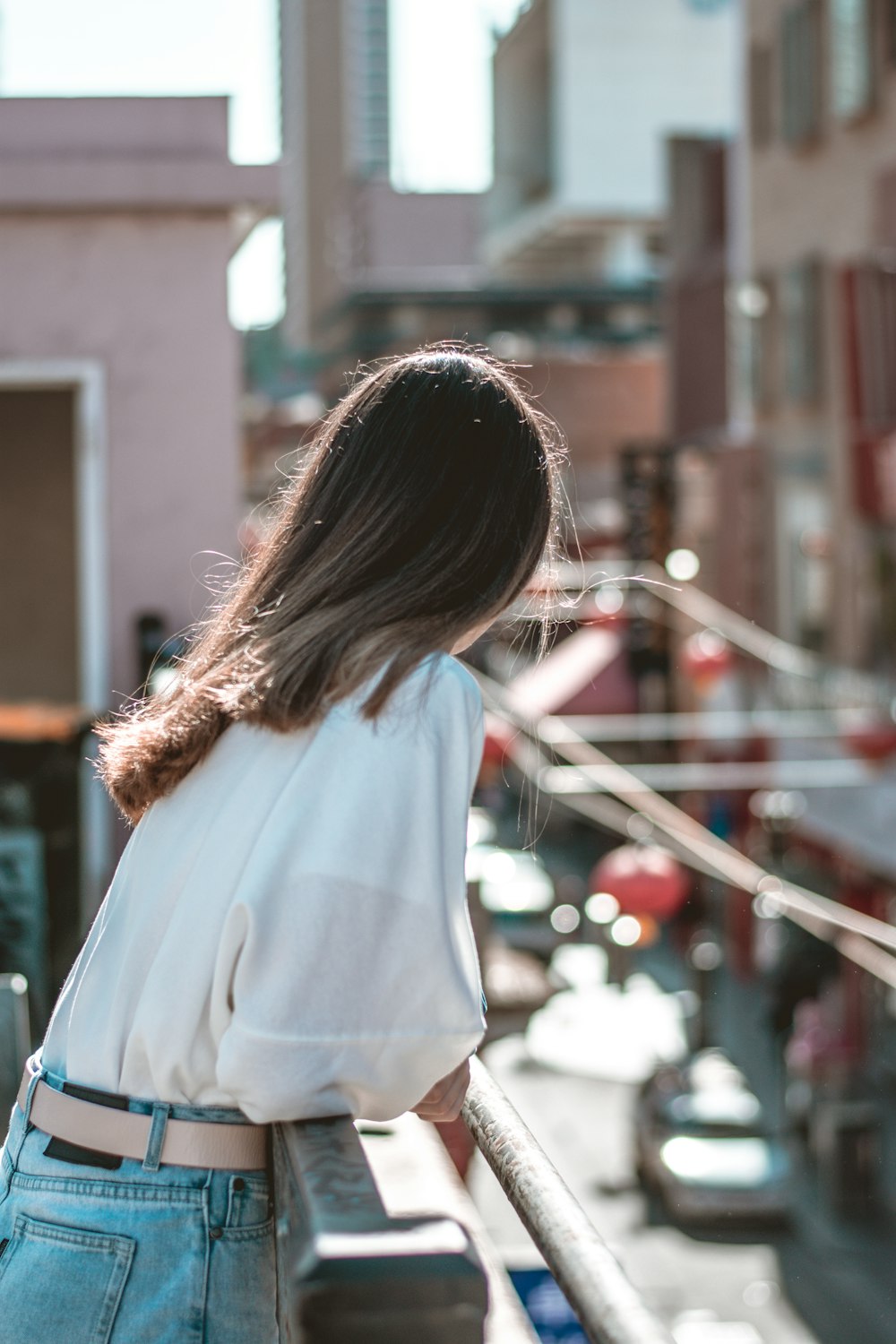 woman in white long sleeve shirt standing near building during daytime