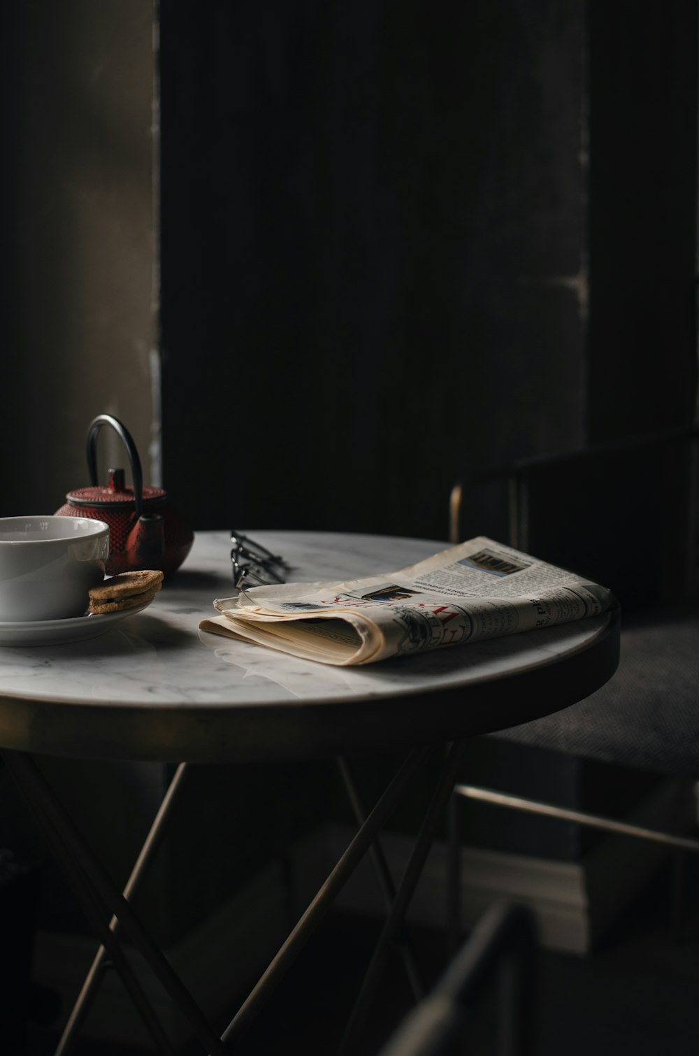 white ceramic teacup on white ceramic plate on brown wooden table