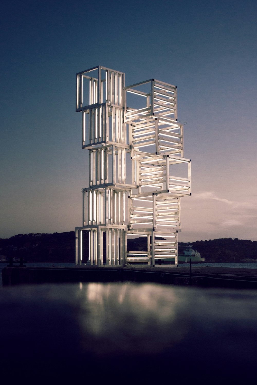 white and brown building near body of water during night time