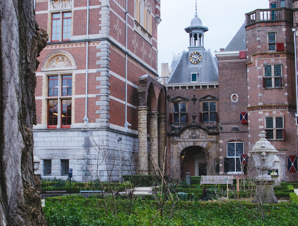 brown brick building with green grass lawn