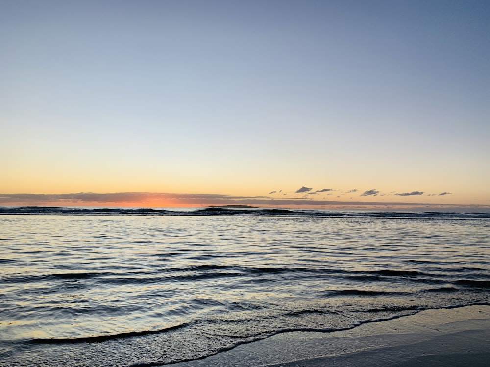 body of water during sunset