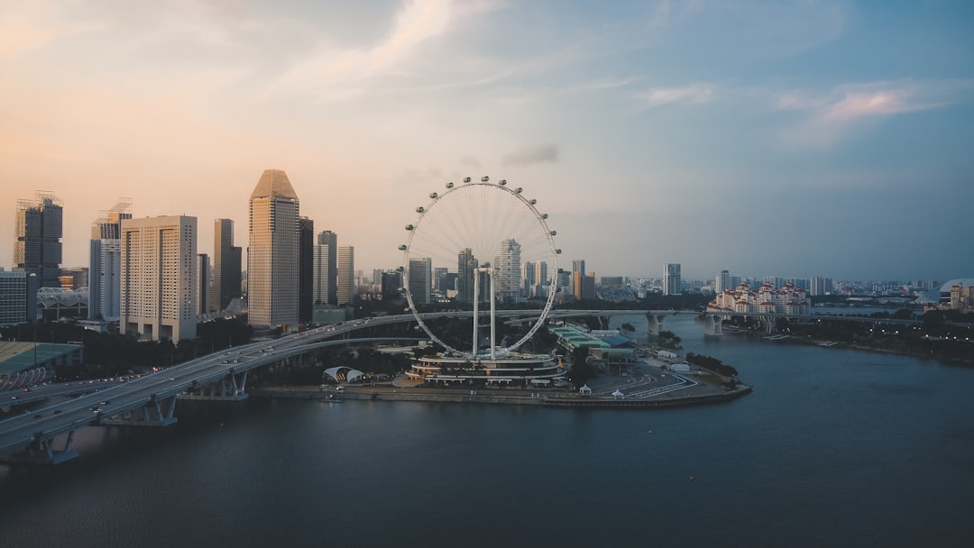 ferris wheel near city buildings during daytime, Sunset over the flyer