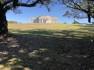 white concrete building near green grass field during daytime