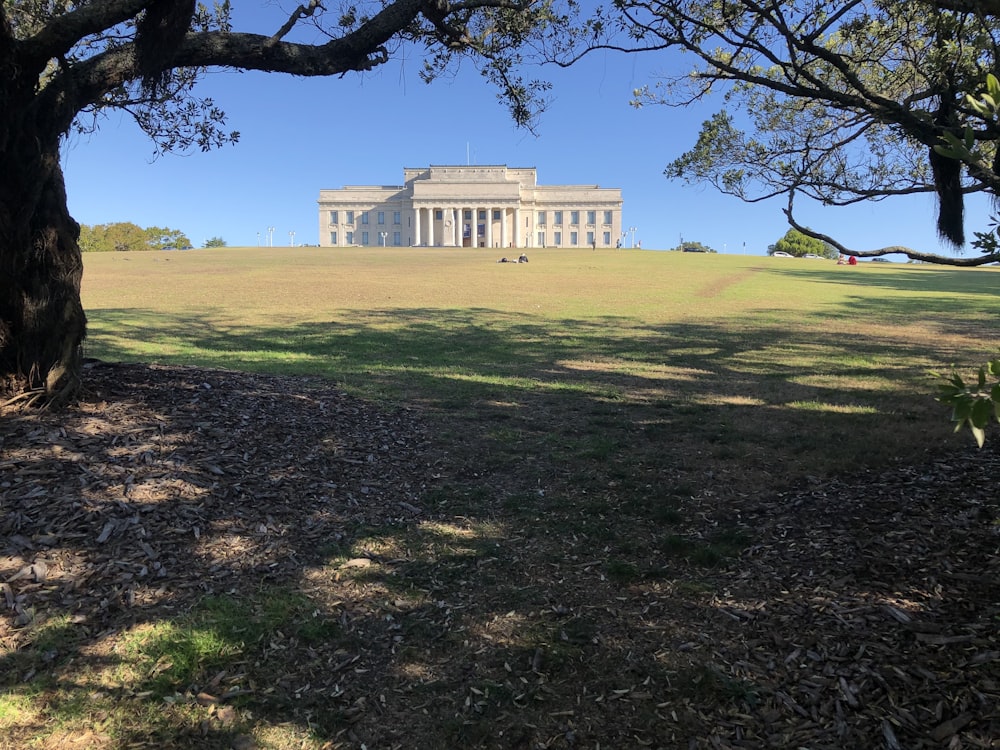 white concrete building near green grass field during daytime