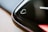 A close-up of the edge of a black smartwatch screen featuring a heart symbol, suggesting a focus on heart rate monitoring. The screen's curved edge reflects light, creating a sleek and modern appearance.