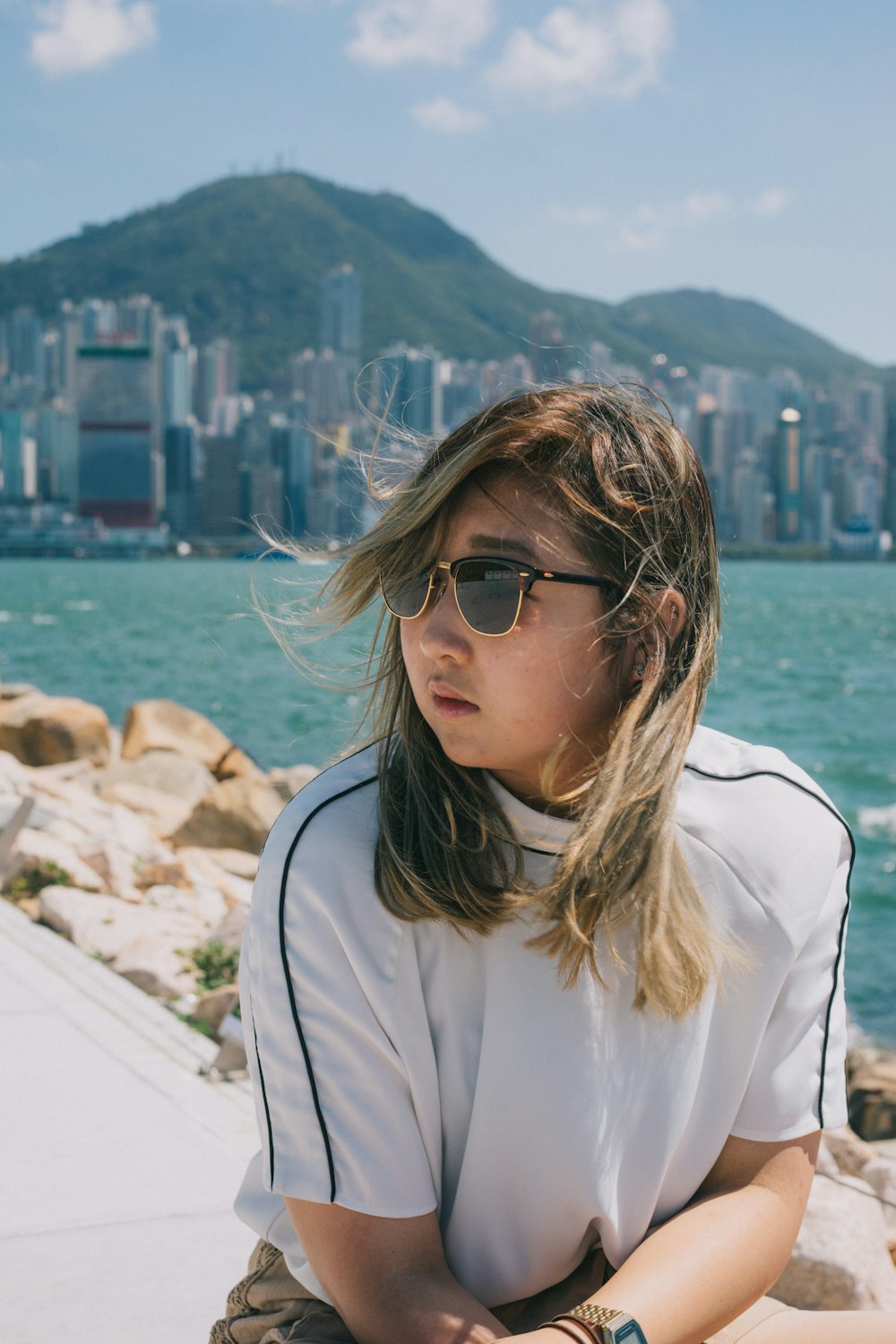 woman in white jacket wearing sunglasses