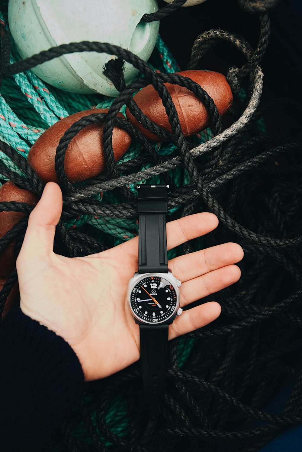 black and silver round analog watch