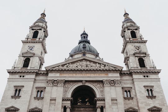 brown and blue concrete building under white sky during daytime in St. Stephen's Basilica Hungary