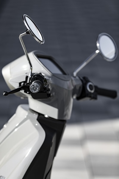 white and black motor scooter