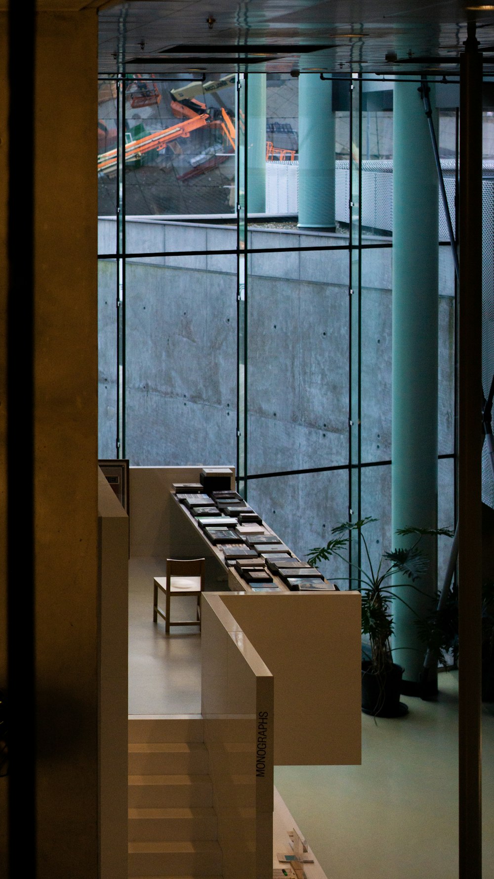 brown wooden table near glass window