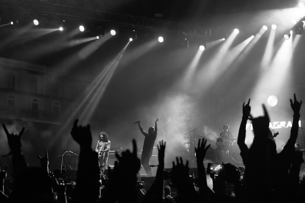 grayscale photo of people on concert