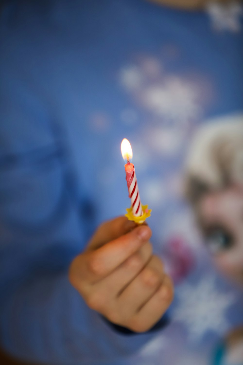 person holding yellow and red candy