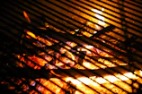 Bright flames licking the edges of charcoal with no smoke visible.