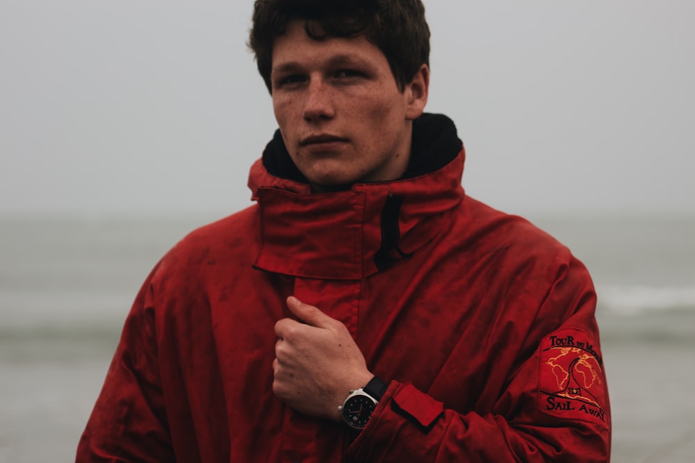 man in red hoodie wearing black sunglasses