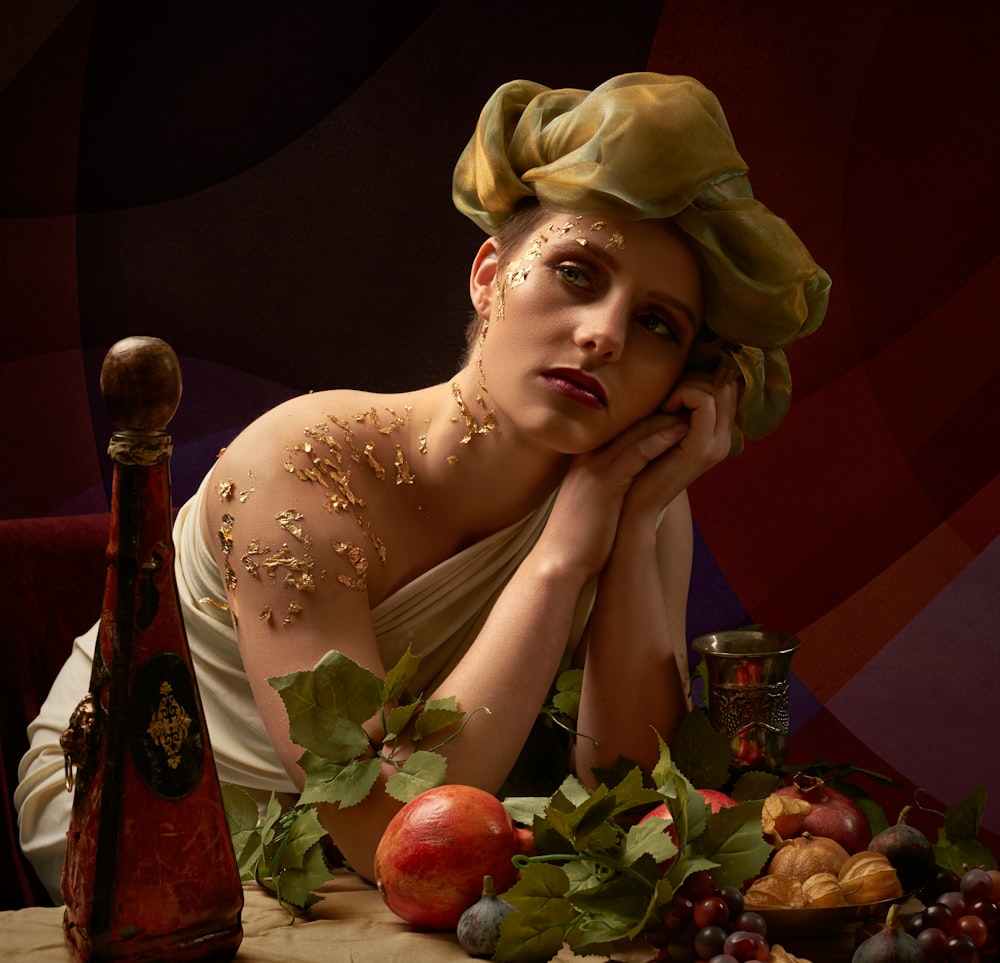 woman in white floral dress holding red apple