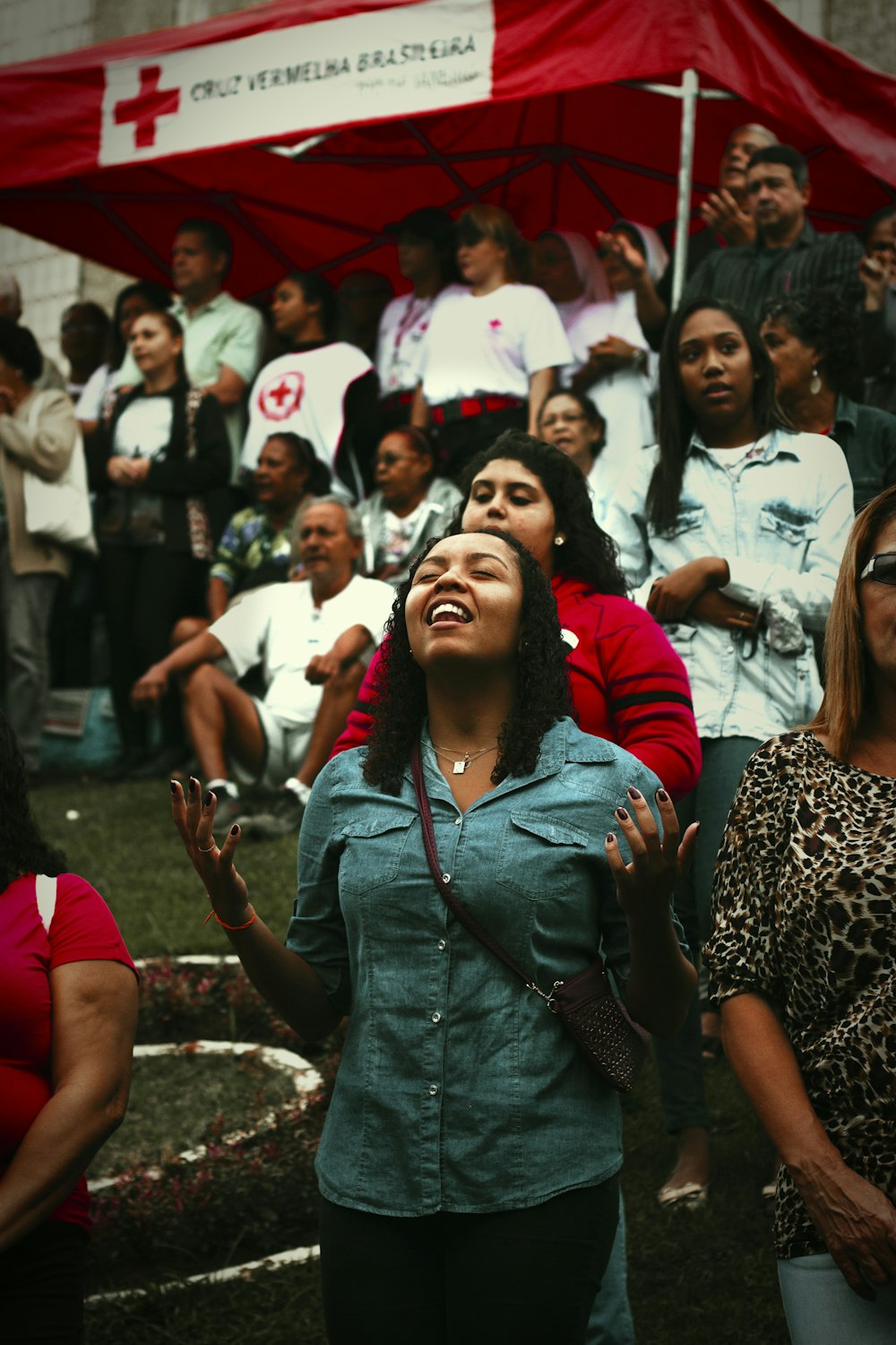 a woman standing in front of a crowd of people