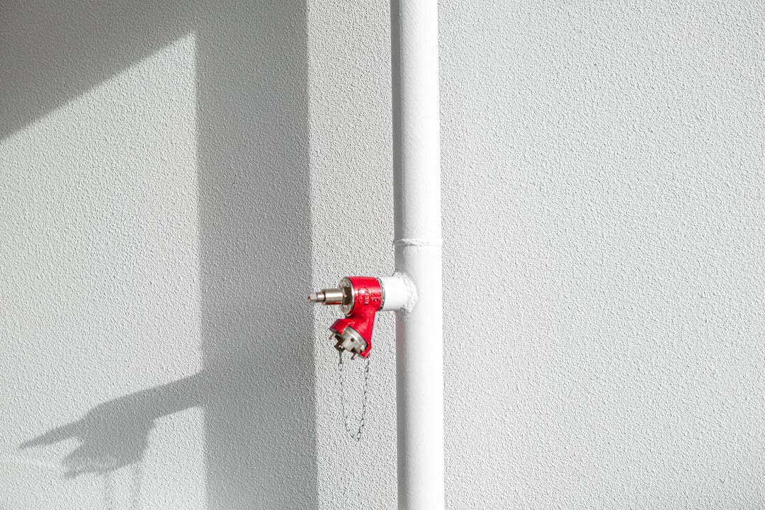 white pipe with red fire extinguisher
