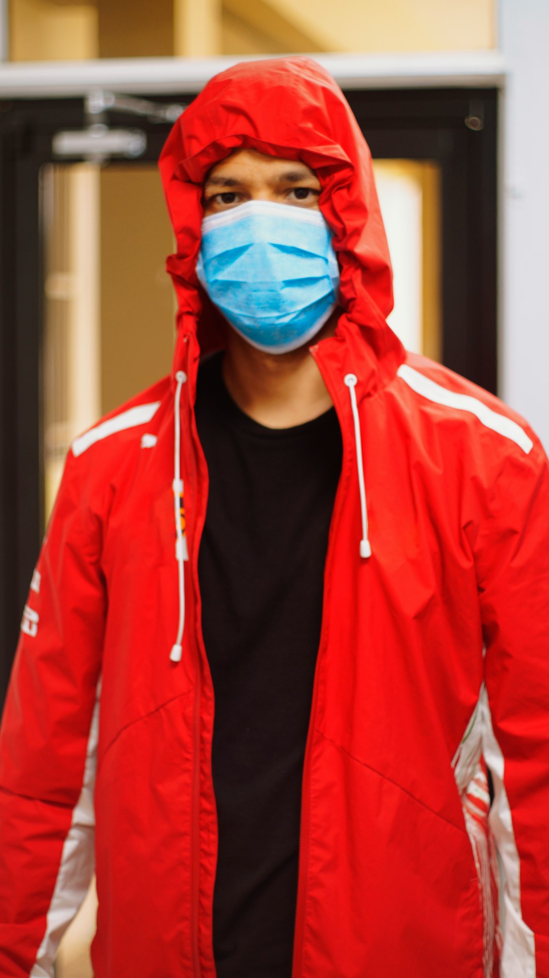 man in red zip up jacket wearing blue mask