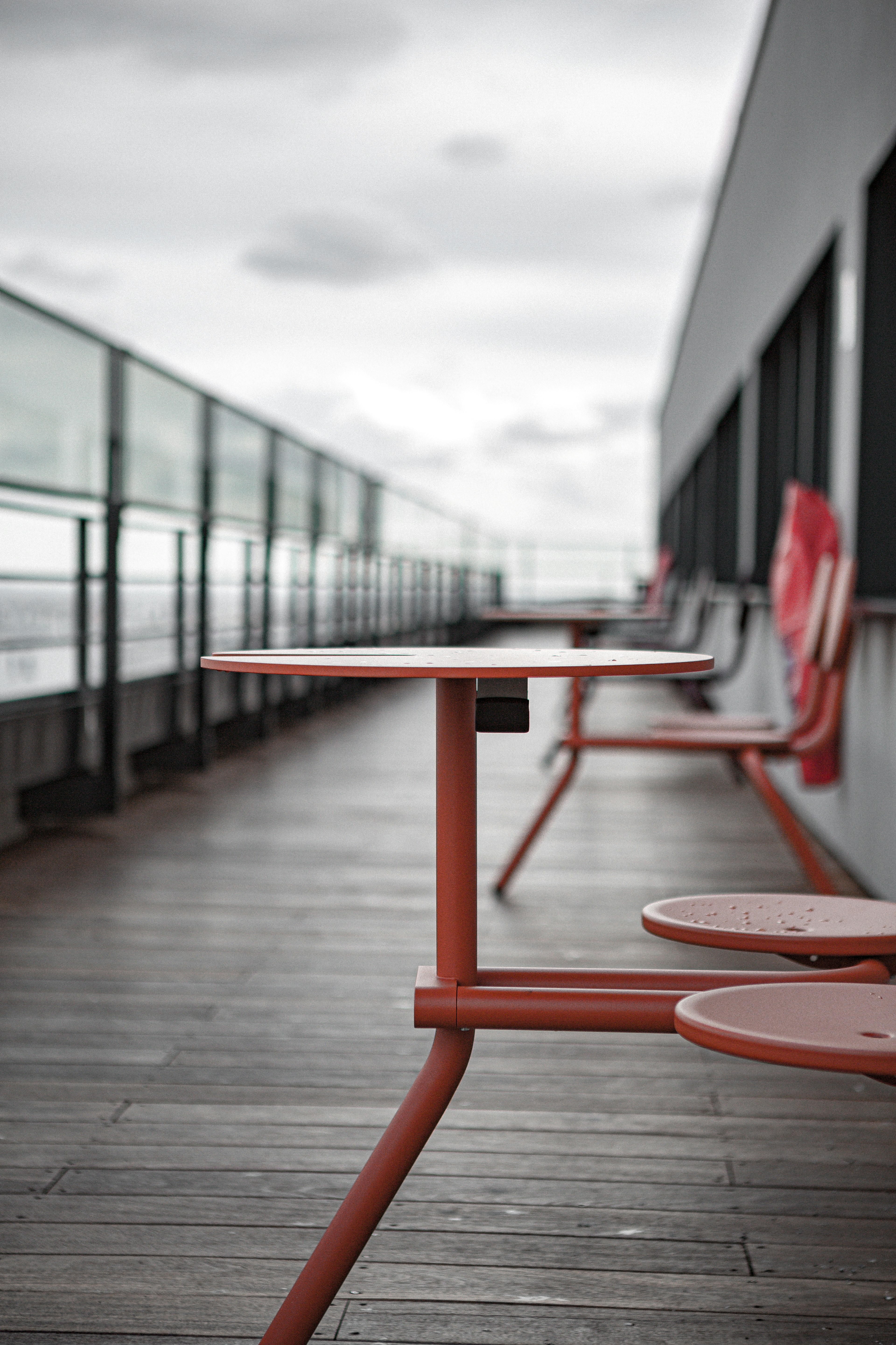 Red metal table and chairs on wooden deck photo Free Furniture Image